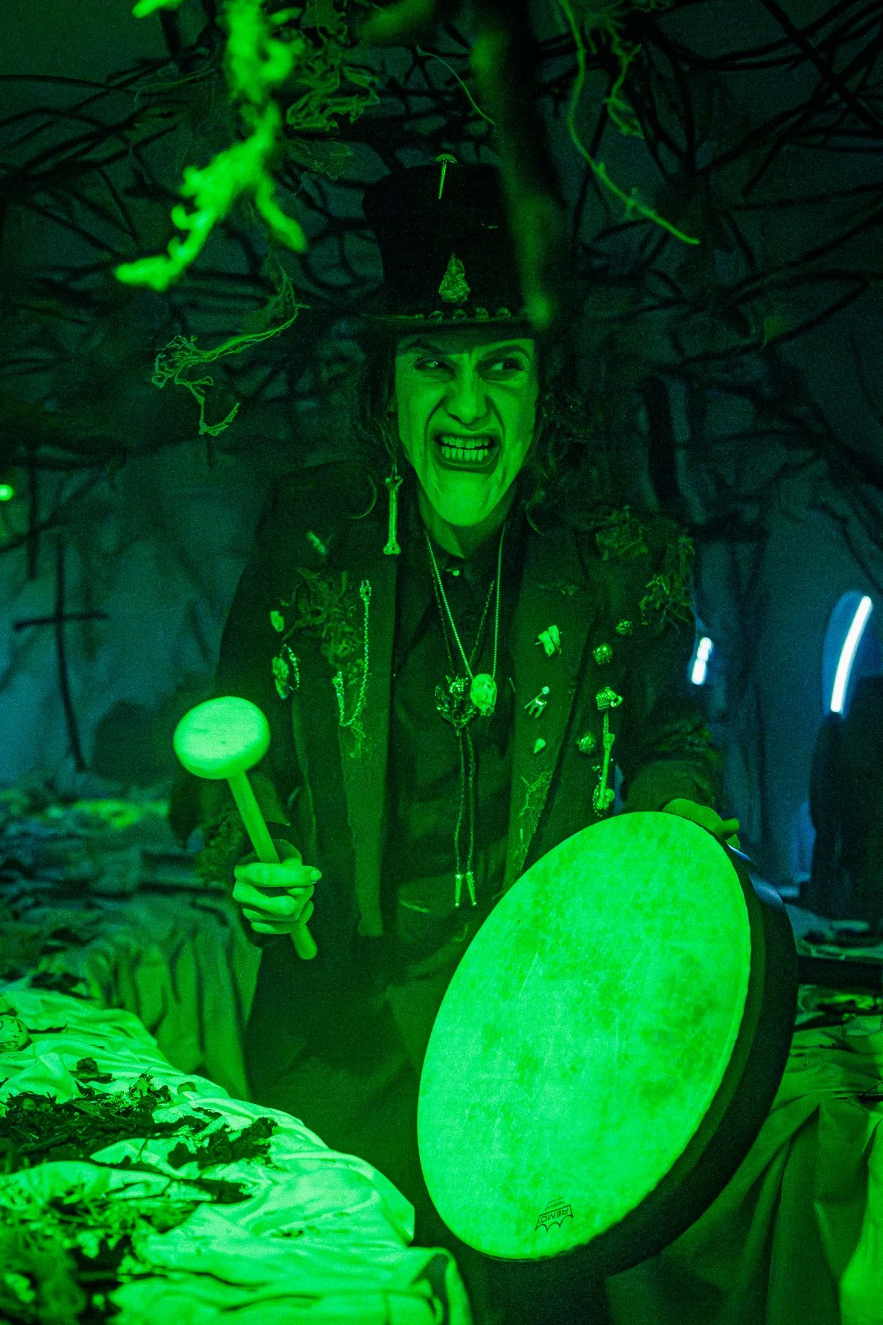 Green forest character room — shaman performer under vivid green overhead wash